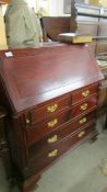 A good mahogany bureau with brass handles.