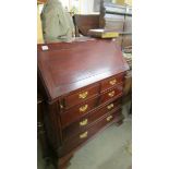 A good mahogany bureau with brass handles.