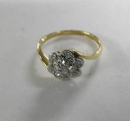 An early 20th century daisy ring stamped 18ct/platinum, size L.