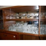 A selection of drinking glasses including a set of 10 vintage Babycham style glasses etc.