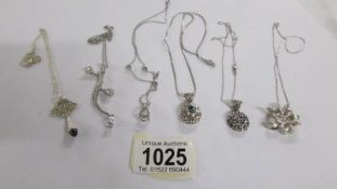 6 assorted silver pendants.