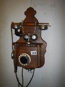 An early 20th century wall telephone, complete but needs slight attention.