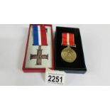 A boxed British Commonwealth veterans cross and a boxed Active Service cross.