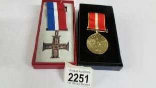 A boxed British Commonwealth veterans cross and a boxed Active Service cross.