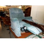 A green/blue fabric manual recliner arm chair