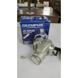 A boxed Olympus IS-5000 camera.