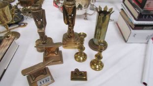 A pair of Heavy bronze anvils on stands, a pair of bronze candlesticks, A trench art vase,