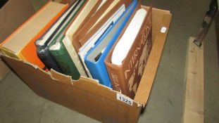 A box of stamp albums and stock books.