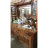 A good quality oak mirror backed sideboard with top side cabinets.