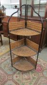 A metal and wicker corner shelf unit.