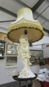 A vintage glazed pottery table lamp in the for of an oriental man complete with shade,