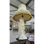 A vintage glazed pottery table lamp in the for of an oriental man complete with shade,