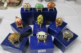 9 boxed Atlas Editions Faberge style eggs with certificates.
