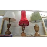 Three craftsman turned wooden table lamps with shades, approximate heights 57 - 65 cm.