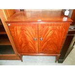 A mahogany finished 2 door cupboard with crossbanded string inlaid doors A/F (please see photos for