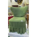 An Edwardian wing nursing chair with green cover.