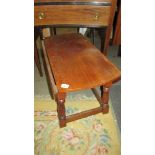 A solid oak drop leaf coffee table.