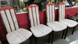 A set of 4 high back dining chairs.