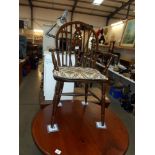 A darkwood wheelback carver chair