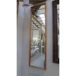 A tall pine framed mirror.