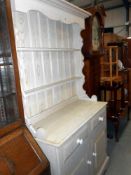 A shabby chic finished solid pine dresser height 197cm, width 107cm approx.