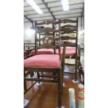 Five oak ladder back chairs being a carver and 4 dining chairs.