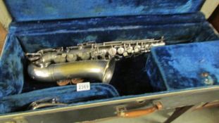 A 1943 Couesnon Paris Model No.3 Alto saxophone in case.
