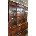 A good mid 20th century feathered mahogany break front bookcase in good condition.