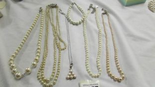 Four 'pearl' necklaces, pendant and bracelet.