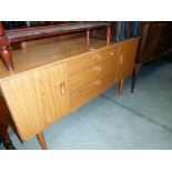 A Schreiber teak effect sideboard, height 72.5cm, width 137cm approx.