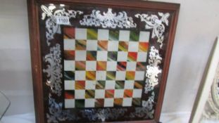 A chess board with mirrored decoration in mahogany frame,