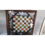 A chess board with mirrored decoration in mahogany frame,