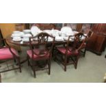 A mahogany extending dining table and a set of 6 shield back dining chairs.