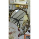 An antique effect gilt framed oval mirror. 54 x 44 cm.
