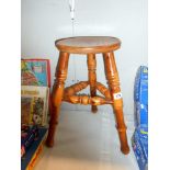 A 3 legged stool with turned legs