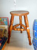 A 3 legged stool with turned legs