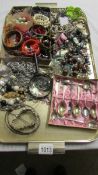 A tray of assorted costume jewellery including rings, bracelets etc.
