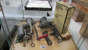 A quantity of vintage kitchenalia including cast iron mincers, bull head can opener etc.