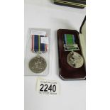 A boxed 'Battle of Britain' medal bar 'Royal Air Force' with a National Service Medal.