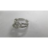 An unusual design diamond ring in a twist style, stamped 9ct white gold, size N.