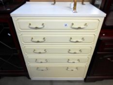 A white melamine bedroom chest with gilded drawer handles, Height 98cm, width 76.