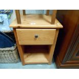 A pine bedside cabinet with a single drawer