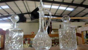 Two square cut glass decanters (stoppers a/f) and one other.