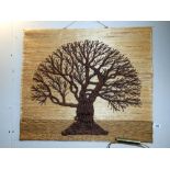 A decorative wall hanging of a tree (crafted from wool on hessian)