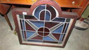 A heavy framed leaded stained glass panel.