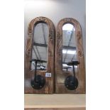 A pair of rustic wooden wall mirrors with candle sconces, 23 x 62 cm (glass need cleaning).
