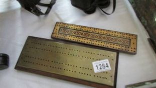 An inlaid Tunbridge ware style cribbage board and a brass cribbage board.