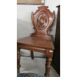 A mahogany hall chair.