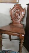 A mahogany hall chair.