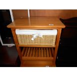 A pine bathroom unit with a wicker drawer, height 59cm, width 51cm approx.